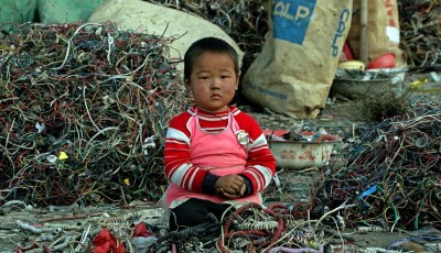 E-Waste-chinese-child-sits-amongst-e-waste